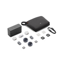 गैलरी व्यूवर में इमेज लोड करें, DJI Mic Mini 2 kit contents laid out on a white background: charging case, black carry pouch, USB-C cable, two transmitters, mobile receiver, clips, magnetic covers, and two fluffy windscreens.
