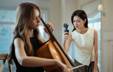 Load image into Gallery viewer, Woman filming a cello player with the DJI Osmo Pocket 4P dual-lens handheld gimbal camera