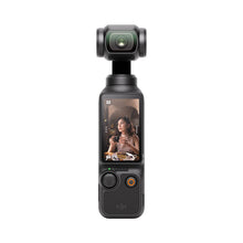 गैलरी व्यूवर में इमेज लोड करें, DJI Osmo Pocket 3 handheld gimbal camera front view with flip touchscreen displaying vlogging shot