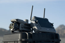 ಗ್ಯಾಲರಿ ವೀಕ್ಷಕಕ್ಕೆ ಚಿತ್ರವನ್ನು ಲೋಡ್ ಮಾಡಿ, DJI RC Plus Drone Remote Controller With A Large Screen And Two Antennas, Viewed From A Low Angle Against A Blue Sky