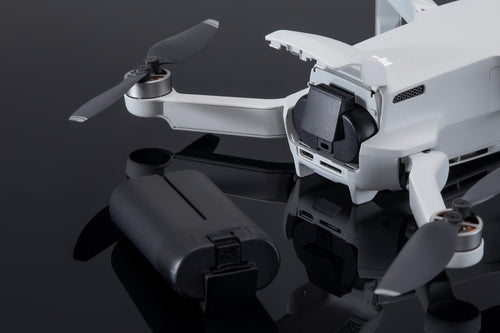 A Close-Up A White DJI Mini Drone With Its DJI Mavic Mini Intelligent Flight Battery 