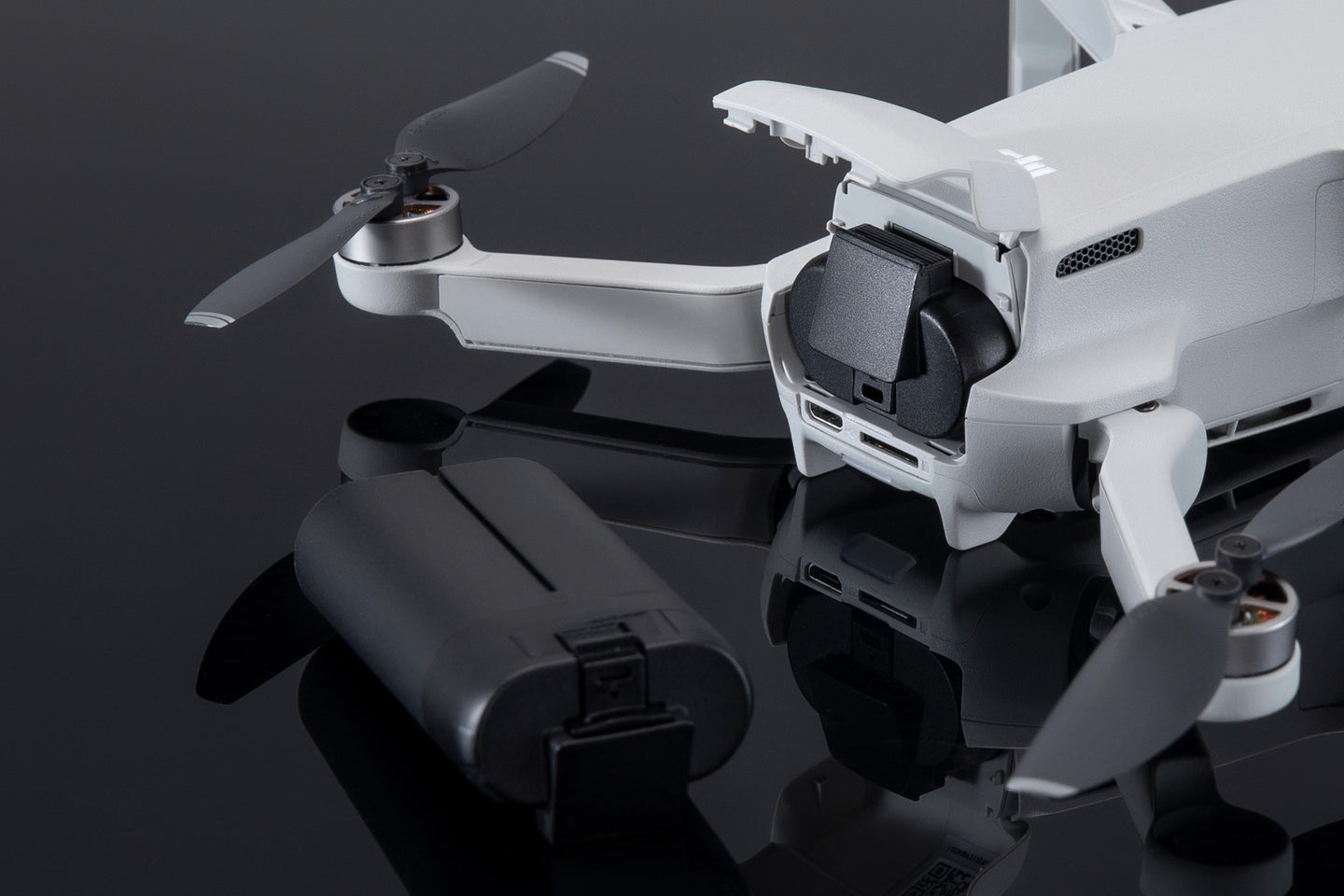 A Close-Up A White DJI Mini Drone With Its DJI Mavic Mini Intelligent Flight Battery 