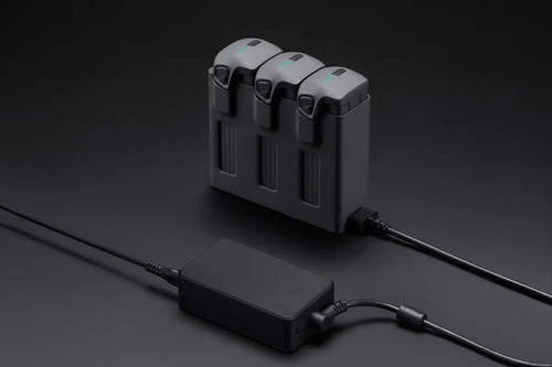 DJI Mavic 240W Power Adapter
With Three Drone Batteries Inserted And Connected To A Power Adapter. 